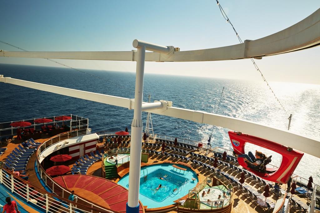 carnival cruise ship deck with sun setting