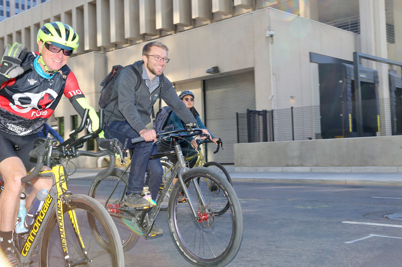 Two men riding two bikes